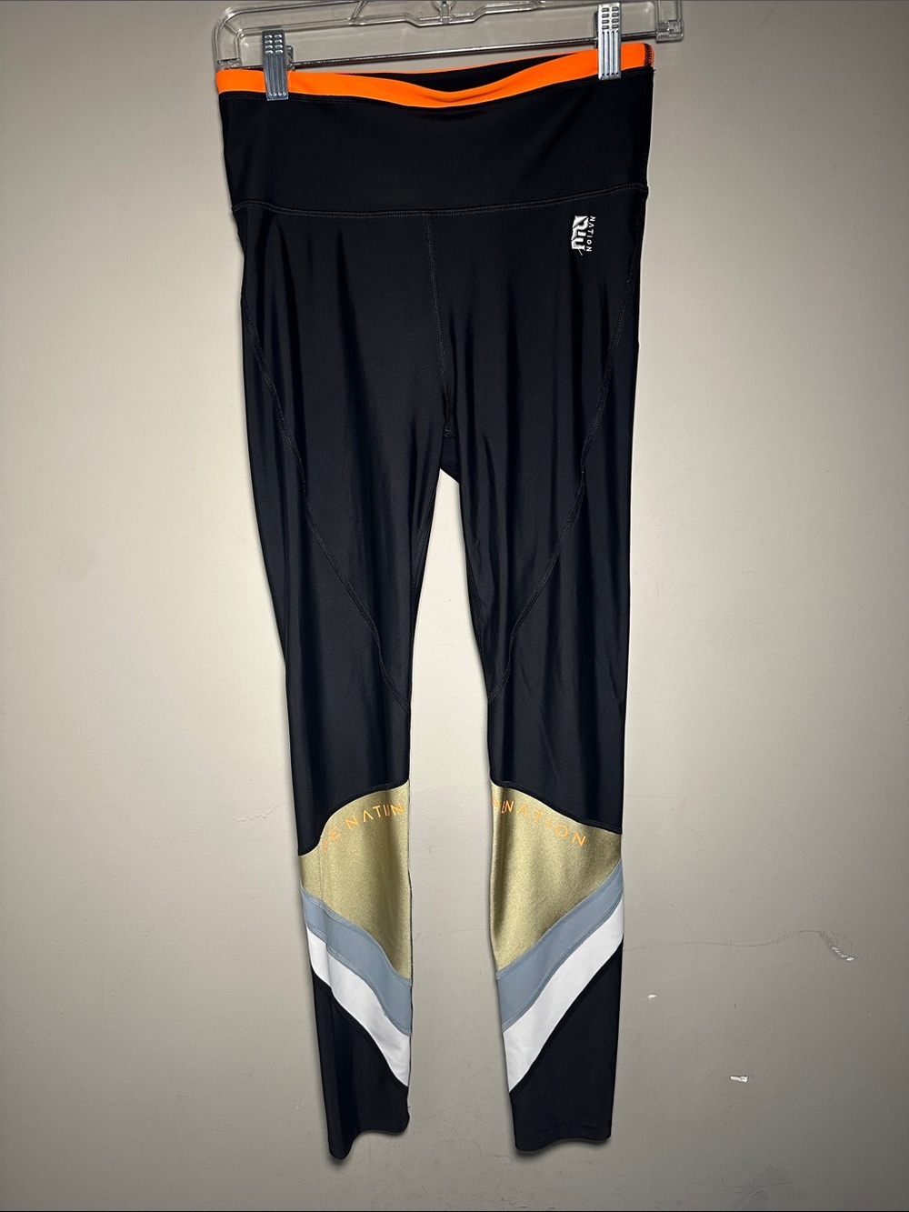 P.E. Nation Ultimate Black Performance Leggings with color-block gold gray white